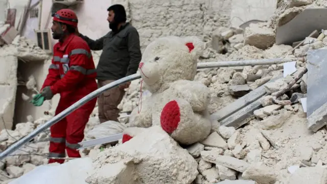 A teddy bear is seen on rubble of a damaged building, in the aftermath of the earthquake in Aleppo, Syria