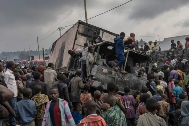 Residents dismantle a vehicle belonging to the United Nations Stabilization Mission in the Democratic Republic of Congo