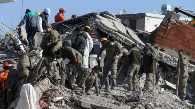 Turkish soldiers search for victims at a collapsed building in the aftermath of a major earthquake in Islahiye district of Gaziantep city,