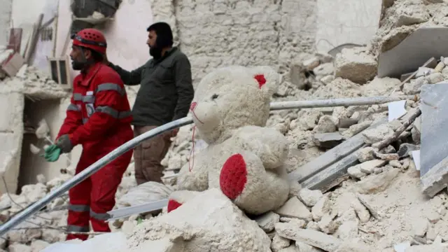 A teddy bear is seen on rubble of a damaged building, in the aftermath of the earthquake in Aleppo,