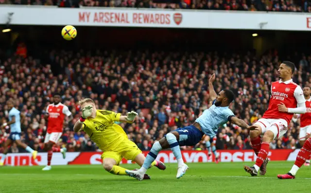 Brentford's Rico Henry in action with Arsenal's Aaron Ramsdale