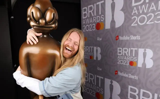 Sam Ryder hugging a Brit award