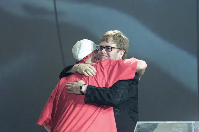 Elton John hugging Eminem