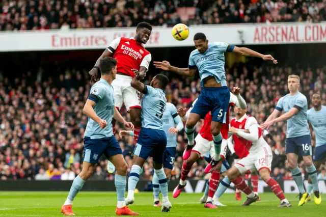 Thomas Partey of Arsenal with a header during the Premier League match between Arsenal FC and Brentford FC at Emirates Stadium on February 11, 2023