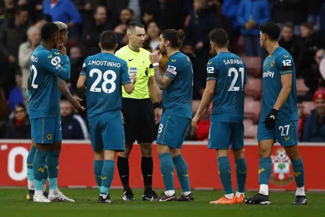 Wolves players argue with referee after red card for Lemina