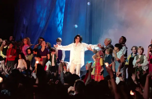 Michael Jackson on stage with children