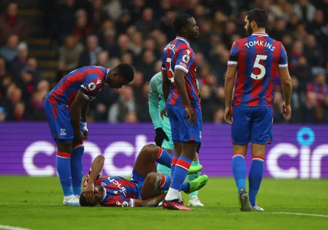 Cheick Doucoure goes down after a challenge from Alexis Mac Allister