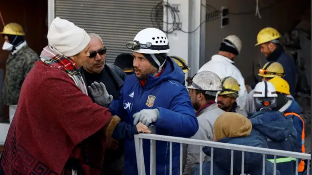 Rescuers speak to people searching for their relatives in Kahramanmaras