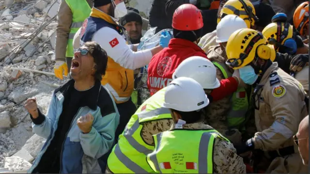 A man is overjoyed as rescuers find his mother alive