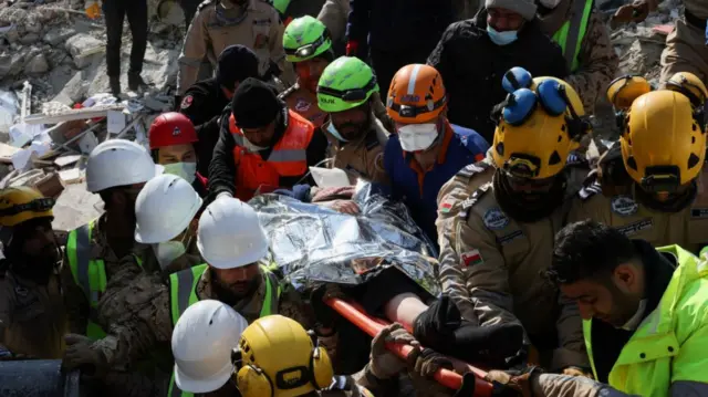 Rescuers carry Saadet Sendag from the rubble