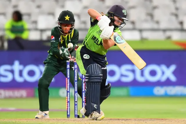 Ireland's Cara Murray (R) is bowled by Pakistan's Nida Dar (not seen) as Pakistan's wicketkeeper Muneeba Ali (L) reacts during the Group B T20 women's World Cup cricket match between Pakistan and Ireland at Newlands Stadium in Cape Town