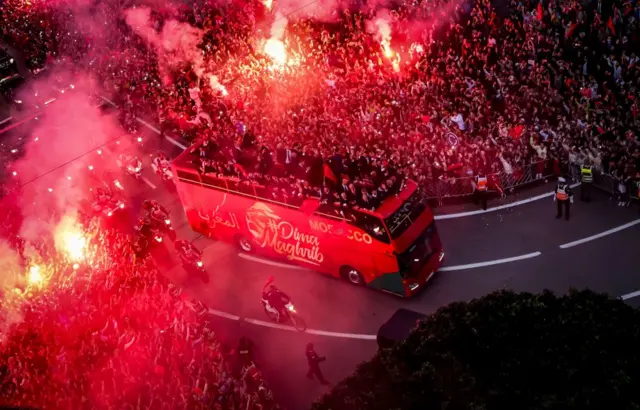 Supporters cheer as Morocco's national football team arrives to the center of the capital Rabat, on December 20, 2022, after the Qatar 2022 World Cup