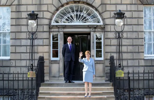 Scotland's re-elected First Minister Nicola Sturgeon (R) and Deputy First Minister John Swinney pose for a photograph on the steps of Bute House in Edinburgh