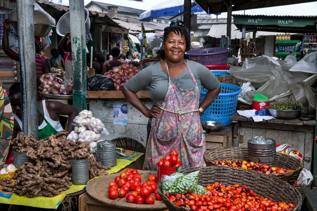 Informal worker Vida Ofori at her vegetable stand at Circle market August 13, 2015 in Accra, Ghana