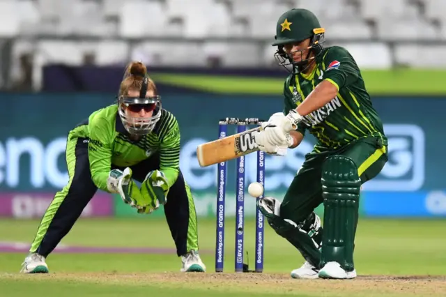 Pakistan's Nida Dar (R) plays a shot as Ireland's Mary Waldron (L) looks on during the Group B T20 women's World Cup cricket match between Pakistan and Ireland at Newlands Stadium in Cape Town