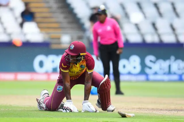 West Indies' Chinelle Henry reacts after being run out by India's wicketkeeper Richa Ghosh (not seen) during the Group B T20 women's World Cup cricket match between West Indies and India at Newlands Stadium in Cape Town