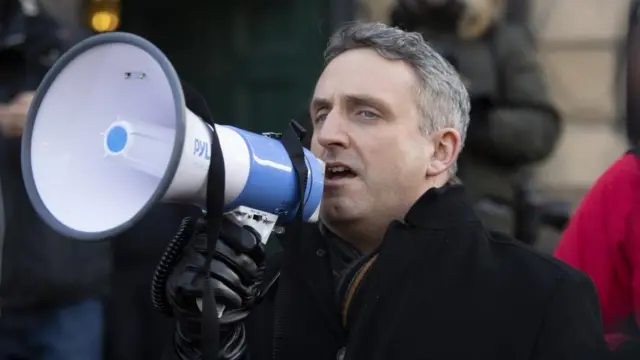 Alex Cole-Hamilton speaks into a megaphone