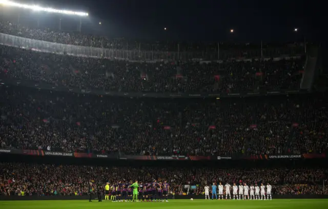 Man United and Barcelona players hold a minute's silence.