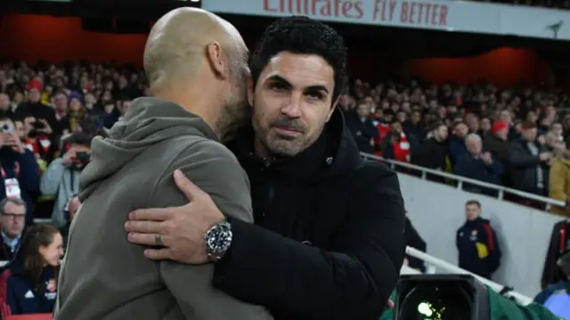 Manchester City manager Pep Guardiola and Arsenal boss Mikel Arteta embrace before Wednesday night's match at the Emirates