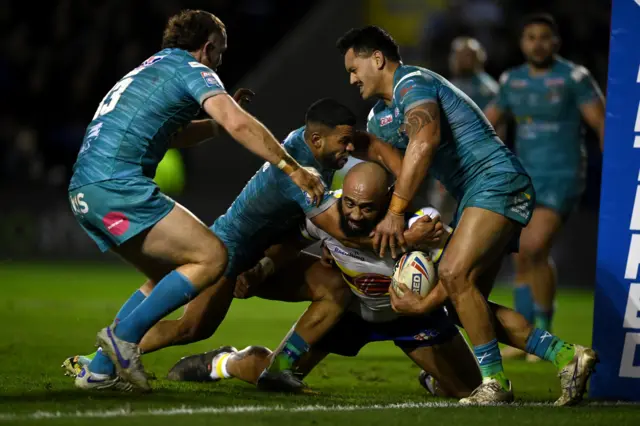 Sam Kasiano is tackled just short of the try line