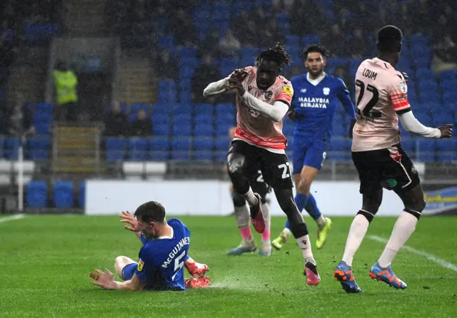 Amadou Mbengue of Reading is tackled by Mark McGuinness of Cardiff City