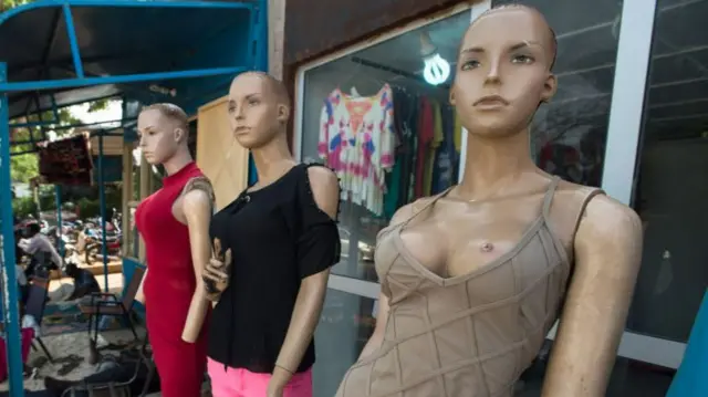 Mannequins line a street