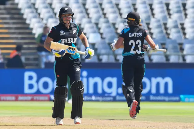 New Zealand's Bernardine Bezuidenhout (L) and New Zealand's Suzie Bates (R) run between the wickets during the Group A T20 women's World Cup cricket match between New Zealand and Bangladesh