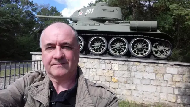 David Smith standing in front of a tank