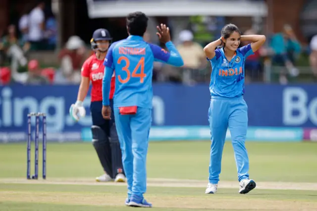 India's Renuka Singh Thakur (R) reacts after almost bowling England's Alice Capsey during the Group B T20 women's World Cup cricket match between England and India at St George's Park in Gqeberha