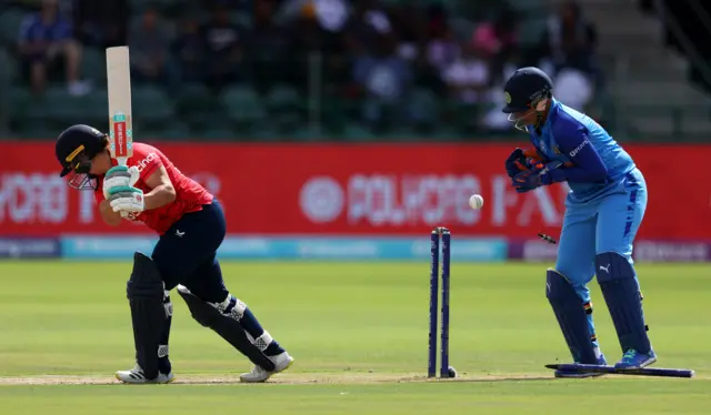 Alice Capsey of England is bowled by Renuka Thakur of India during the ICC Women's T20 World Cup group B match between England and India at St George's Park