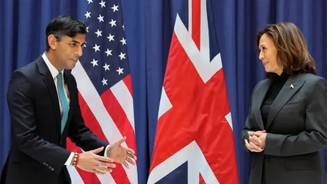 UK Prime Minister Rishi Sunak (left) and US Vice-President Kamala Harris in front of national flags