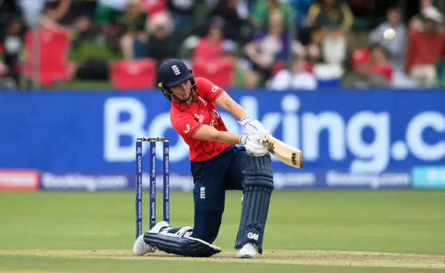 Amy Jones of England hits a six against India