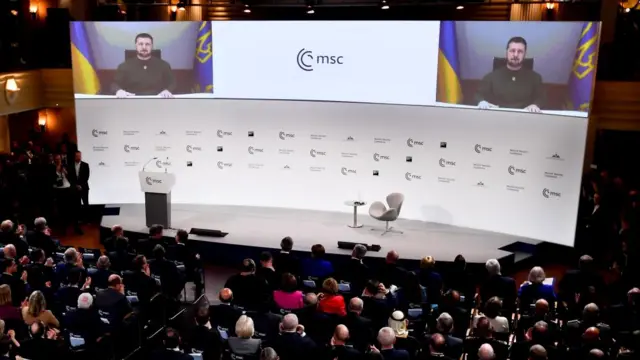 Ukrainian President Volodymyr Zelensky appears on a screen at the Munich Security Conference