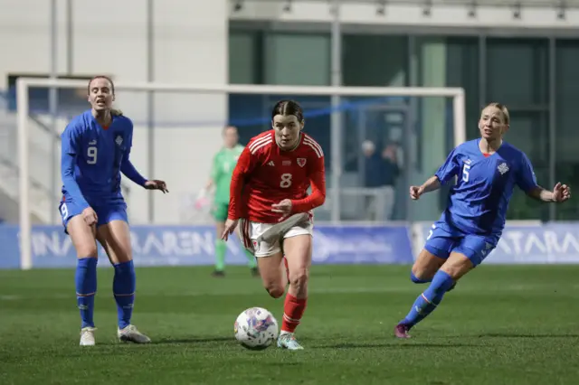 Angharad James drives forward for Wales