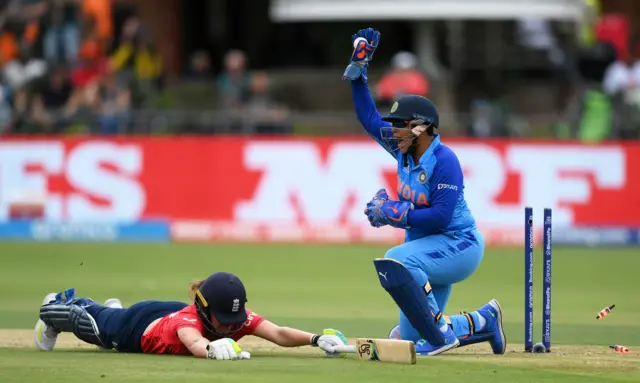 Richa Ghosh of India appeals as Nat Sciver-Brunt of England dives to make their ground during the ICC Women's T20 World Cup group B match between England and India at St George's Park