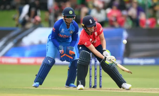 Heather Knight of England plays a shot as Richa Ghosh of India keeps during the ICC Women's T20 World Cup group B match between England and India at St George's Park