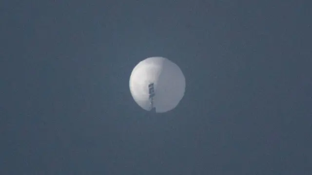 A large white balloon in the sky over the US