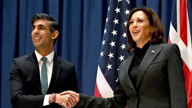 Rishi Sunak shakes hands with Kamala Harris in front of US and UK flags