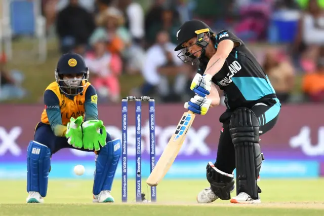 New Zealand's Bernardine Bezuidenhout (R) plays a shot as Sri Lanka's wicketkeeper Anushka Sanjeewani (L) looks on during the Group A T20 women's World Cup cricket match between New Zealand and Sri Lanka at Boland Park