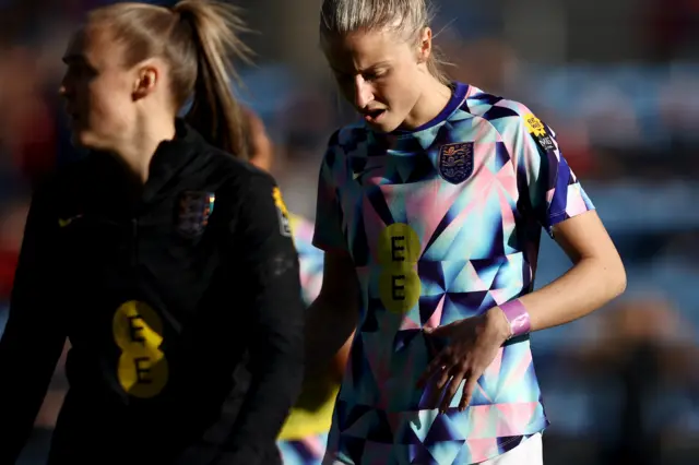 Leah Williamson of England warms up whilst wearing a purple wristband during the Arnold Clark Cup match between England and Italy at CBS Arena