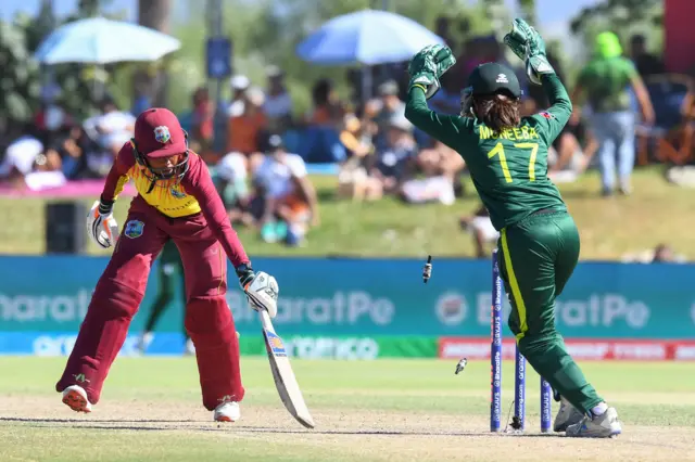 West Indies' Shemaine Campbelle (R) plays a shot as Pakistan's wicketkeeper Muneeba Ali (L) reacts during the Group B T20 women's World Cup cricket match between Pakistan and West Indies at Boland Park