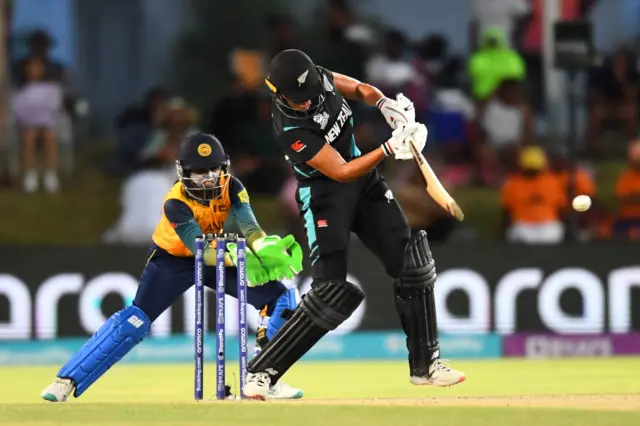 New Zealand's Suzie Bates (R) plays a shot as Sri Lanka's wicketkeeper Anushka Sanjeewani (L) reacts during the Group A T20 women's World Cup cricket match between New Zealand and Sri Lanka at Boland Park in Paarl