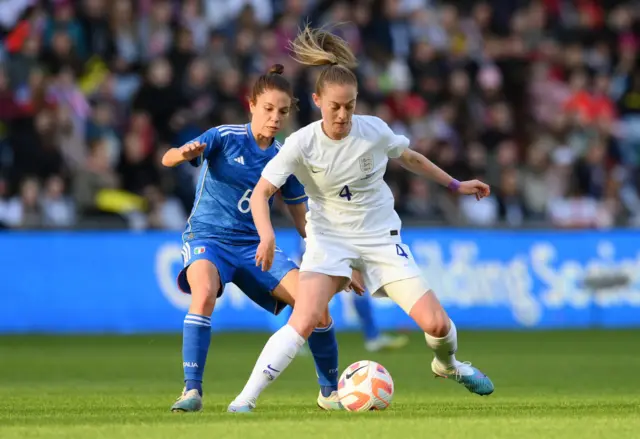 Keira Walsh of England is challenged by Manuela Giuliano of Italy