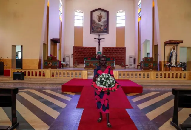 Asunta Santino, 58-year-old, church worker prepares flowers at the St. Theresa Cathedral Parish in Kator, ahead of Pope Francis's visit to Juba, South Sudan