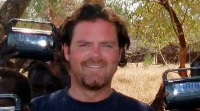 U.S. diplomat John Granville (C) poses in this undated photo from the U.S. Agency for International Development