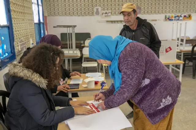 A Tunisian citizen arrives to cast her vote at a polling station during the second round of parliamentary elections in Tunis, Tunisia on January 29, 2023