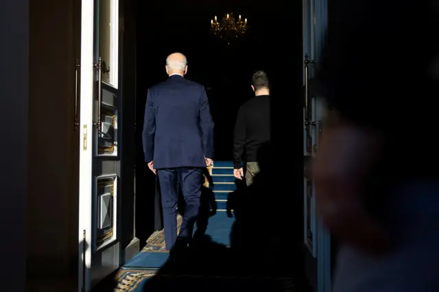 Ukraine's President Volodymyr Zelensky and U.S. President Joe Biden enter the Mariinskyi Palace