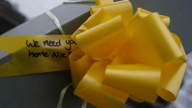 Yellow ribbon tied to bridge