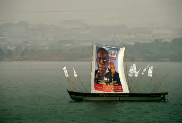 A banner of candidate of the ruling All Progressives Congress (APC) Bola Tinubu and running mate Kashim Settima is displayed on a boat in a lagoon in Lagos, on February 20, 2023.