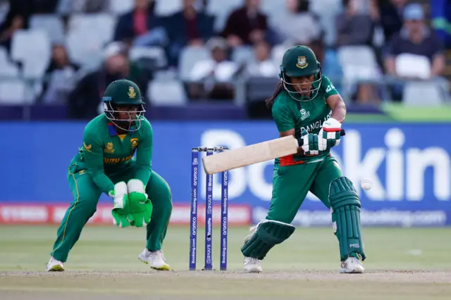 Bangladesh's Shamima Sultana (R) plays a shot while South Africa's wicketkeeper Sinalo Jafta (L) during the Group A T20 women's World Cup cricket match between South Africa and Bangladesh at Newlands Stadium